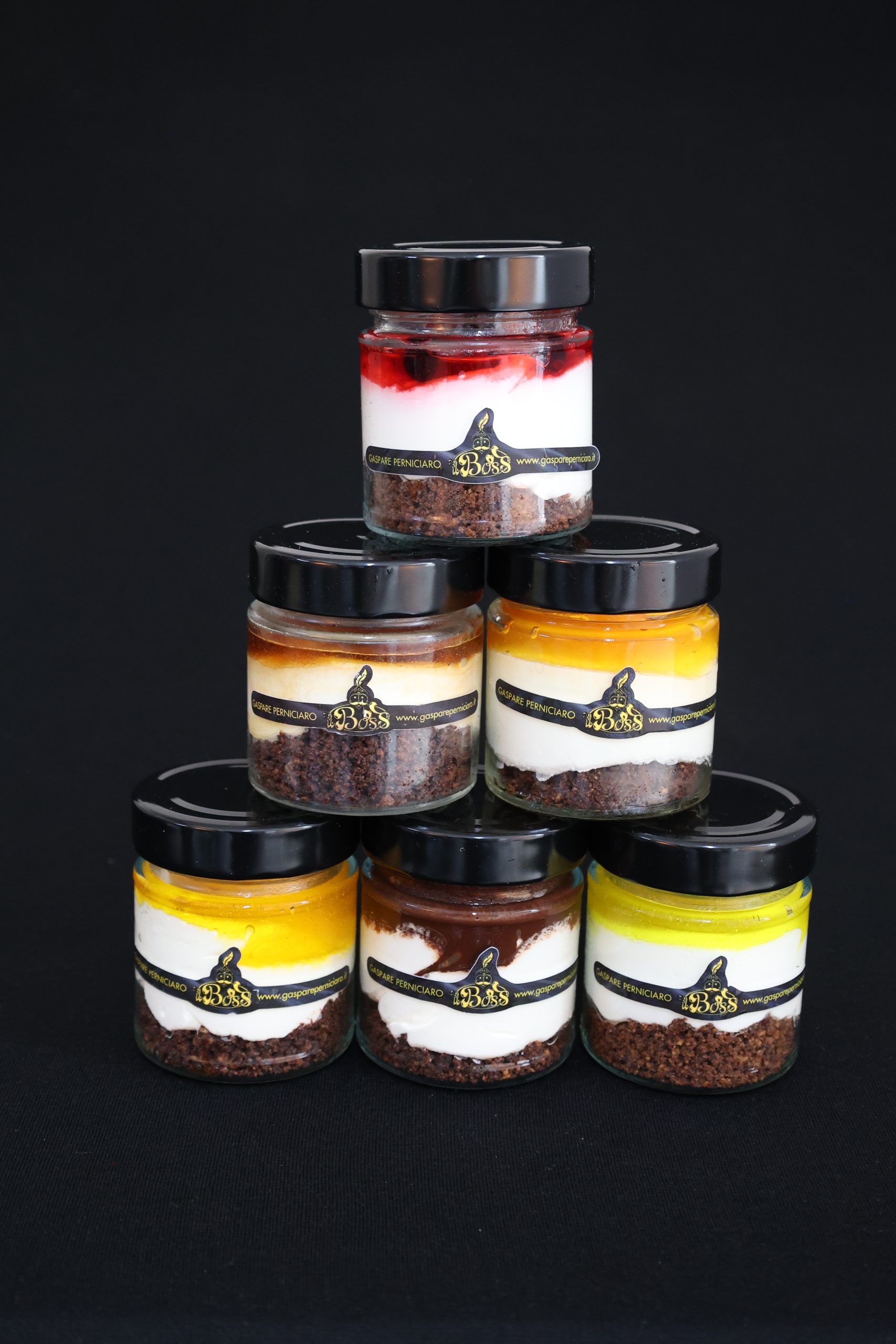 Cheesecake artigianali in vasetto disposte a piramide, foto catalogo del kit misto di dessert per degustazione e prova qualità, ideale per locali e rivenditori con trasporto refrigerato in 48 ore.