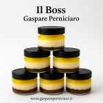 Mini Cheesecake al Limone artigianale da 80 g servita in vasetto di vetro trasparente, con crema vellutata, topping al limone e base croccante di biscotto.