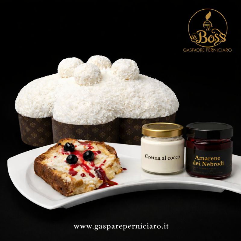 Colomba artigianale Cocco e Amarene Il Boss Gaspare Perniciaro fotografata su fondo nero elegante, con glassa al cocco, fetta servita su piatto, vasetto di crema al cocco e vasetto di amarene dei Nebrodi, packaging originale visibile